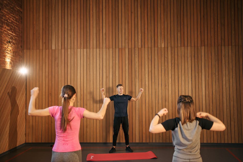 group fitness class trainer teaching empty gym hall
