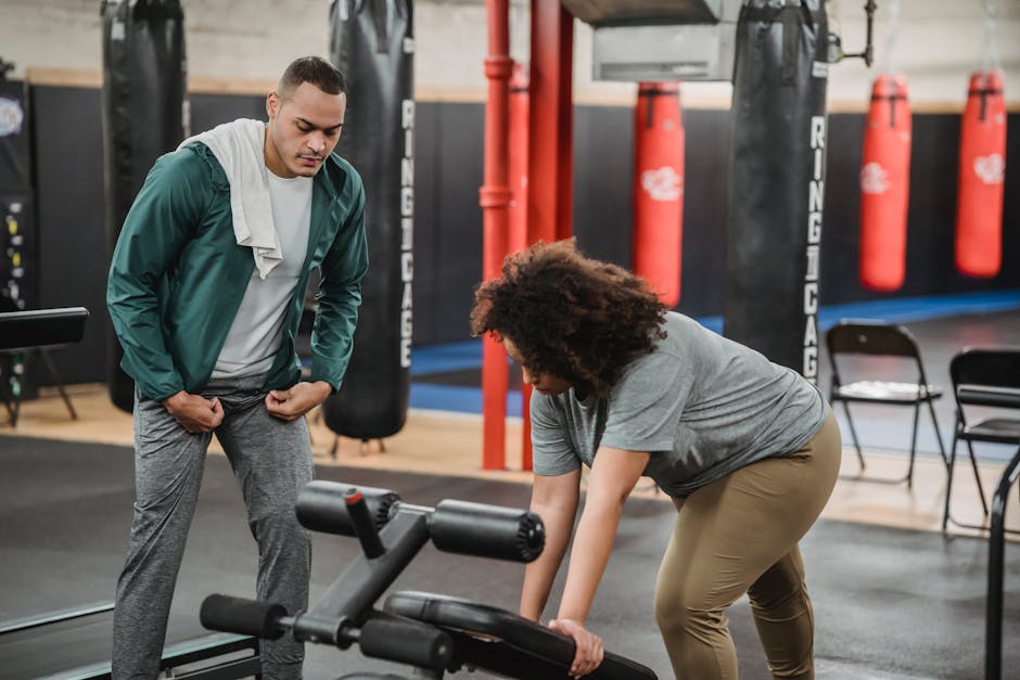 fitness trainer working with clients gym success