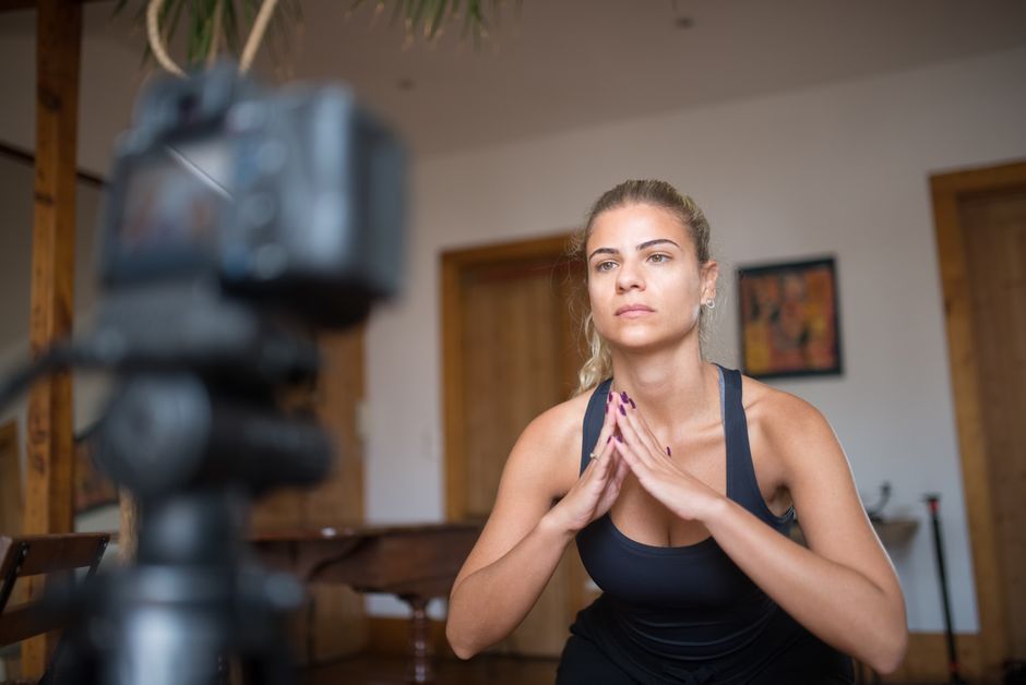 personal trainer explaining exercise technique camera